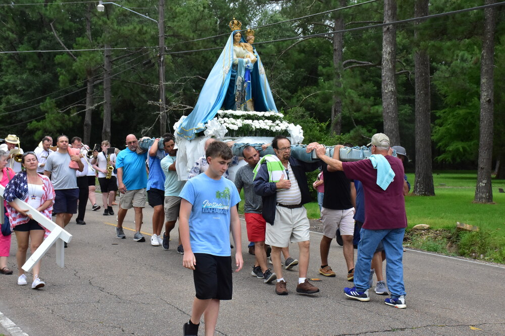 Parishioners carrying the statue
